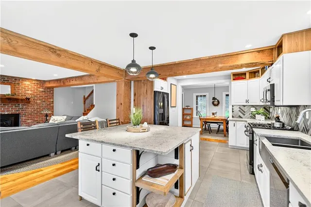a kitchen with a table chairs stove and cabinets