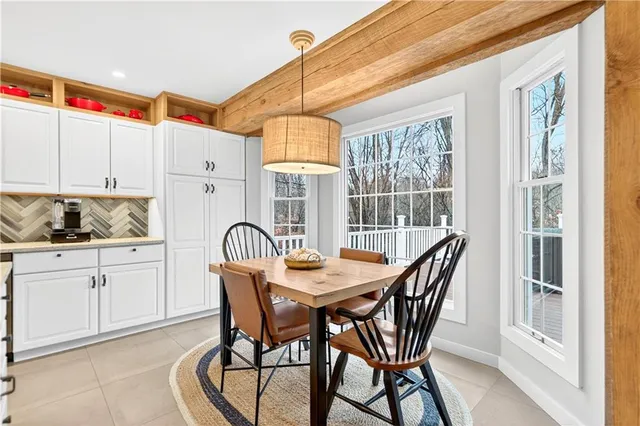 a dining room with furniture and window