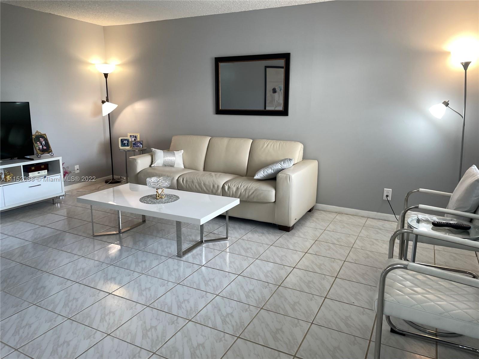 Kings Point Delray Beach, FL 33484 - Photo 12 of 69 a living room with furniture a flat screen tv and rug