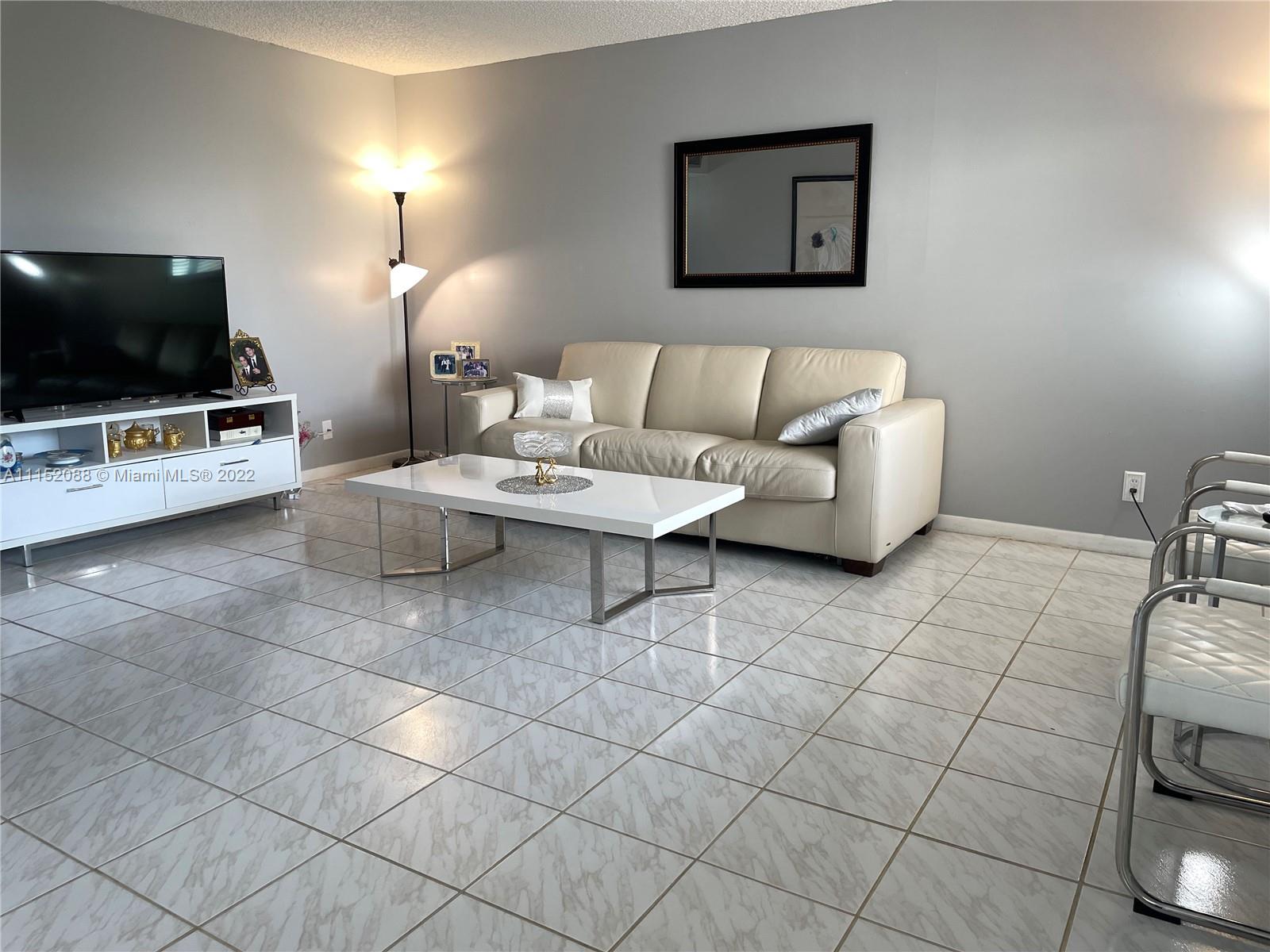 Kings Point Delray Beach, FL 33484 - Photo 13 of 69 a living room with furniture and a flat screen tv