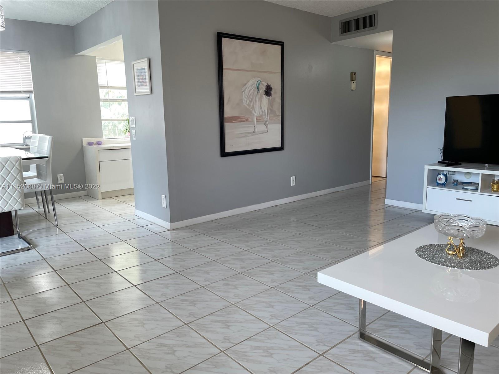 Kings Point Delray Beach, FL 33484 - Photo 17 of 69 a living room with furniture and a flat screen tv