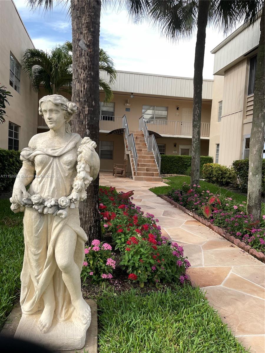 Kings Point Delray Beach, FL 33484 - Photo 2 of 69 a front view of a house with a yard and fountain