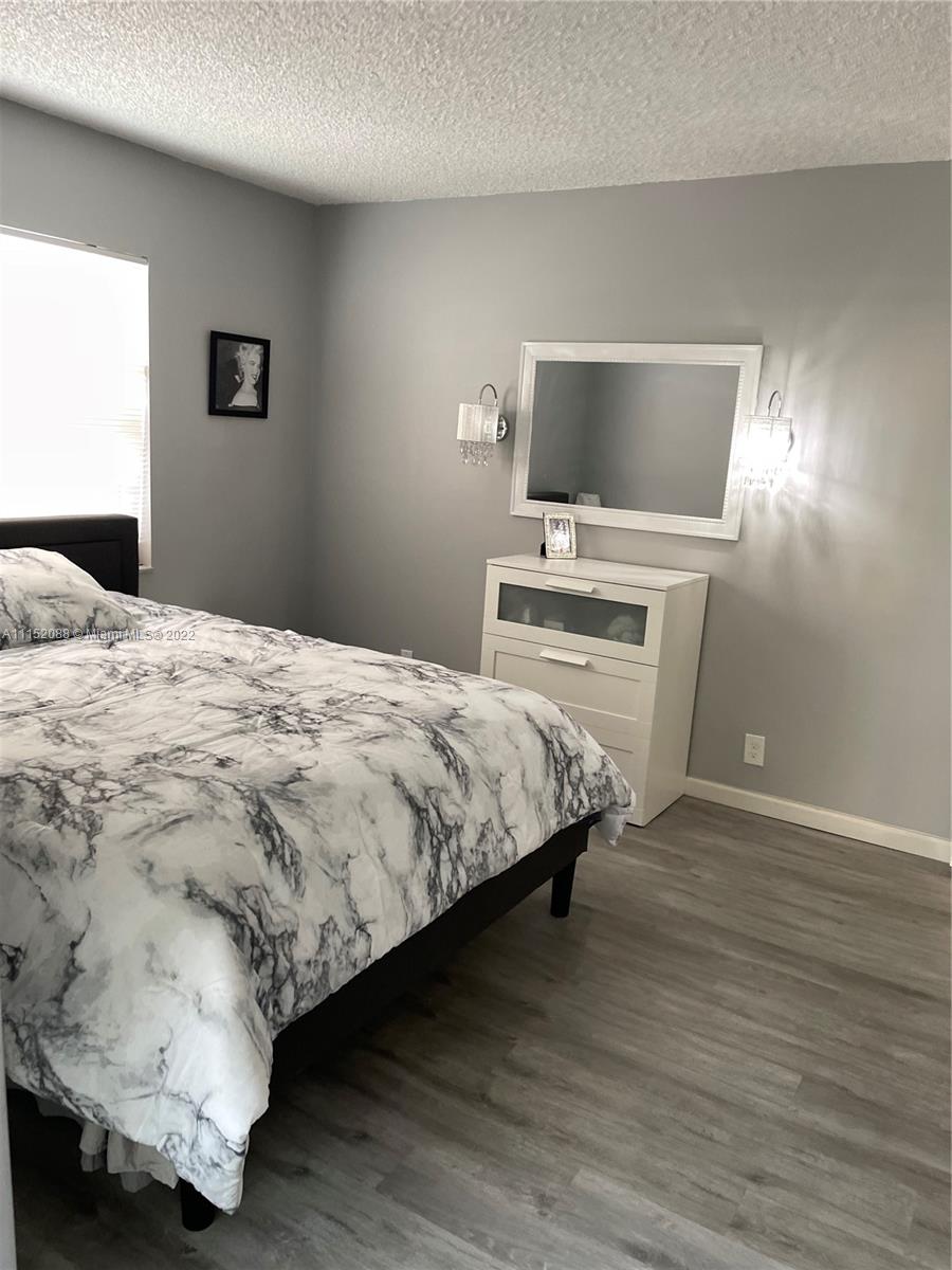 Kings Point Delray Beach, FL 33484 - Photo 28 of 69 a bedroom with a bed and a flat screen tv