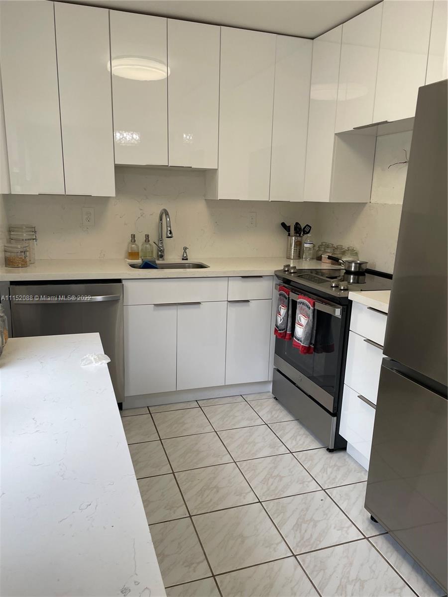 Kings Point Delray Beach, FL 33484 - Photo 50 of 69 a kitchen with stainless steel appliances granite countertop a stove a sink and a white cabinets