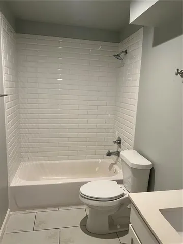 a bathroom with a toilet and a bath tub