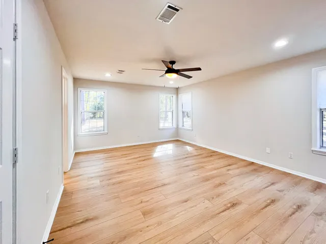 wooden floor in an empty room with a window