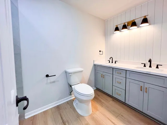 a bathroom with a toilet a sink and mirror