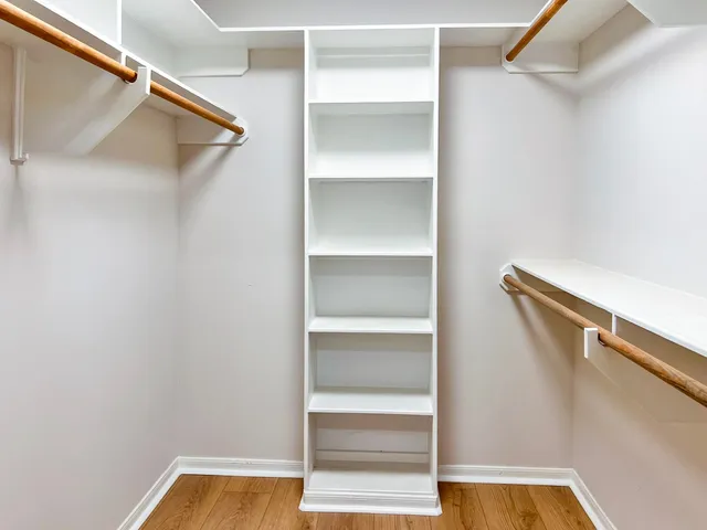 a view of walk in closet with empty racks