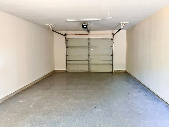 a view of room that has a bed and a ceiling fan