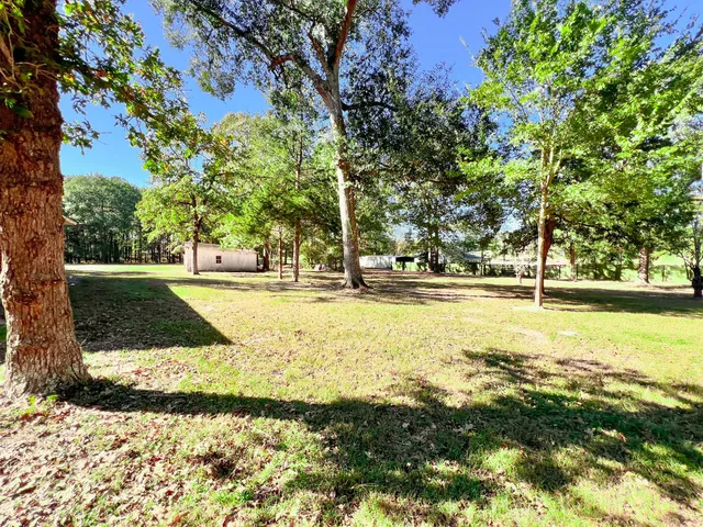 a swimming pool with trees in the background