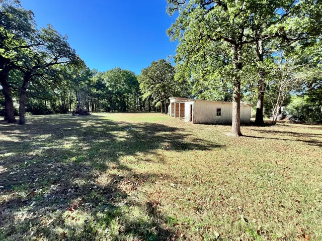 a view of a house with yard and sitting area