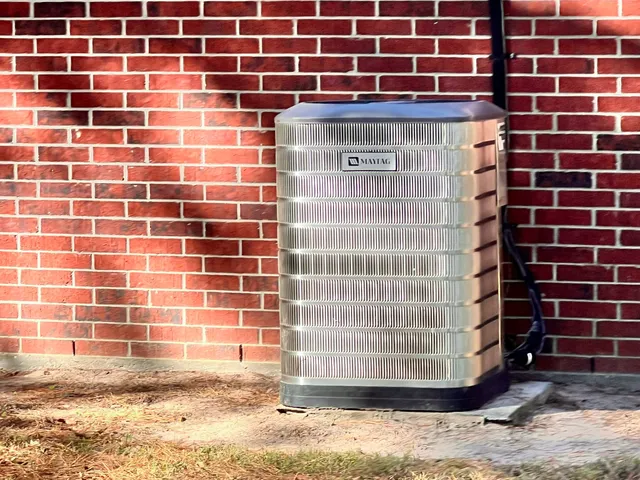 a view of a house with a big yard and large trees