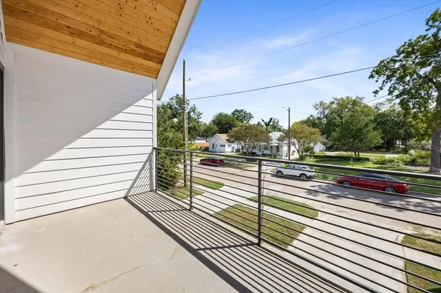a view of a street with wooden fence