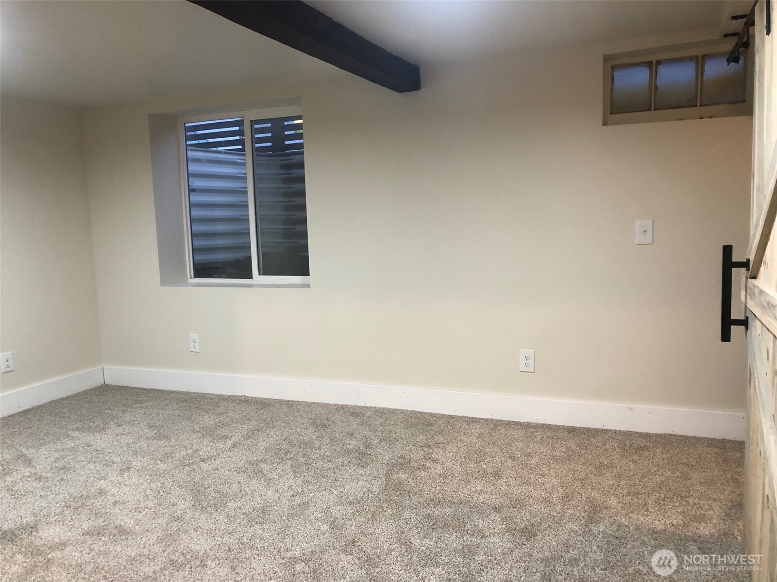 5703 North Wall Street Spokane, WA 99205 - Photo 12 of 23 an empty room with a window and a flat screen tv
