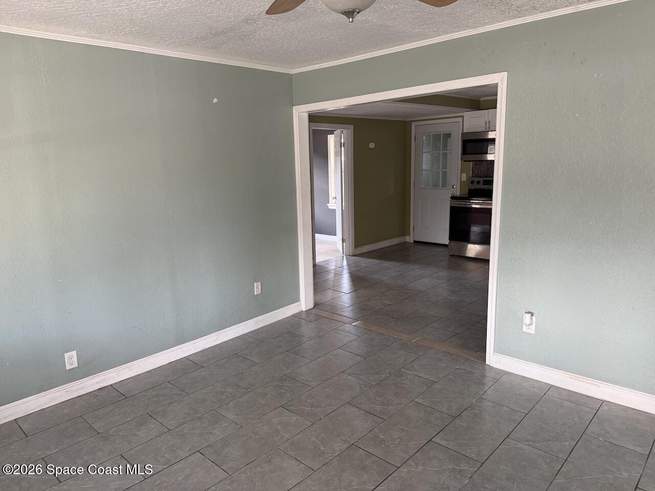 1666 Terrace Street Cocoa, FL 32922 - Photo 2 of 12 an empty room with an entryway and fan