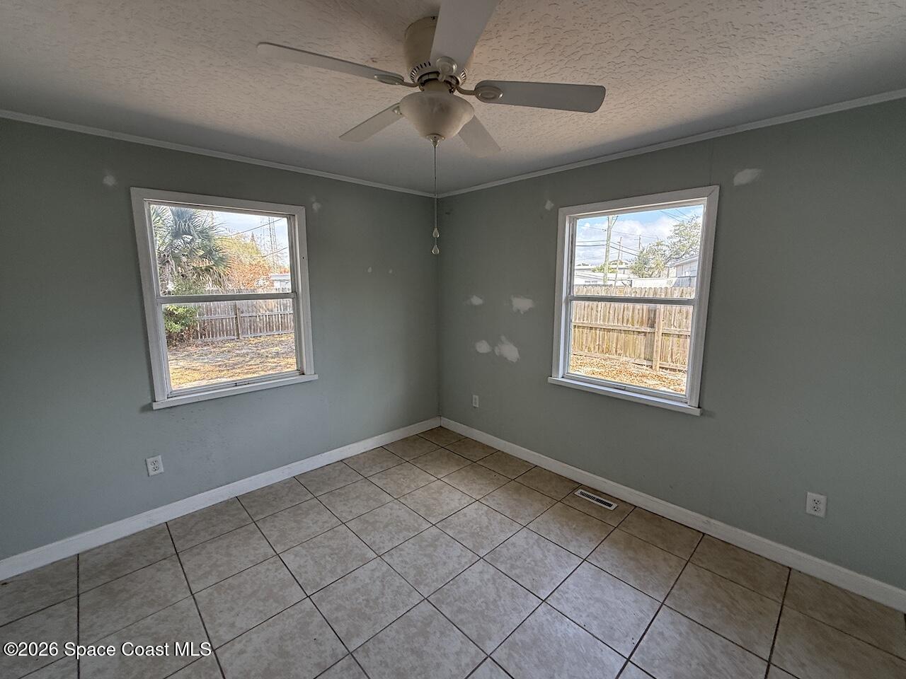 1666 Terrace Street Cocoa, FL 32922 - Photo 5 of 12 an empty room with windows and fan