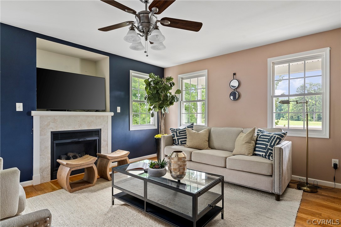 a living room with furniture a fireplace and a flat screen tv
