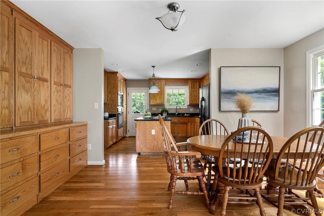 13514 Old Stage Road Hopewell, VA 23860 - Photo 13 of 42 a dining room with furniture a chandelier and wooden floor
