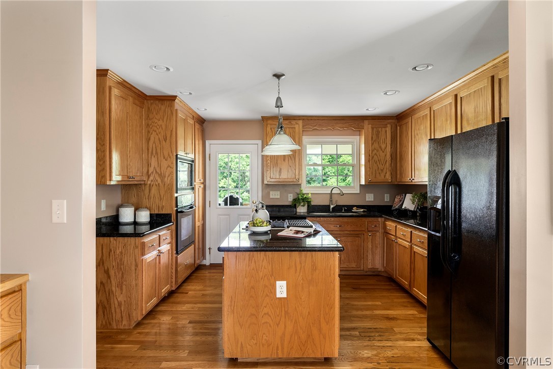 13514 Old Stage Road Hopewell, VA 23860 - Photo 16 of 42 a kitchen with stainless steel appliances granite countertop a stove top oven a refrigerator a sink dishwasher with a dining table and chairs
