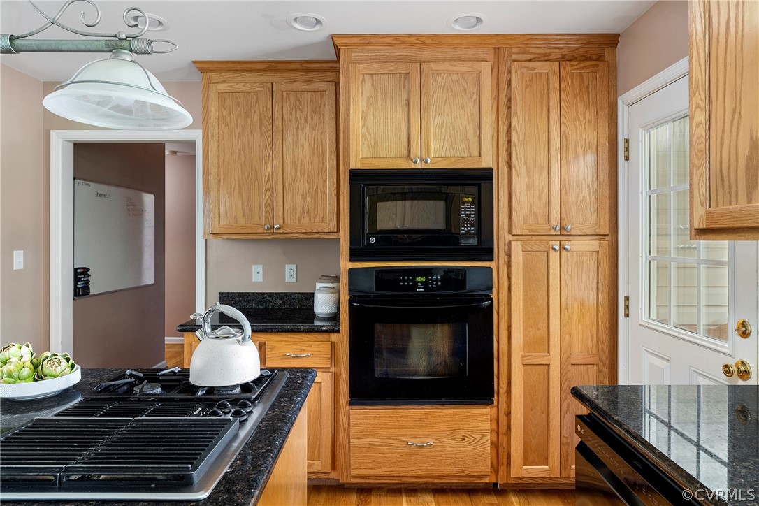 13514 Old Stage Road Hopewell, VA 23860 - Photo 18 of 42 a kitchen with wooden cabinets and a stove top oven