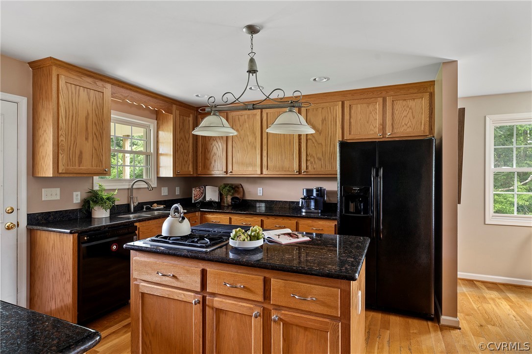 13514 Old Stage Road Hopewell, VA 23860 - Photo 19 of 42 a kitchen with granite countertop a refrigerator a sink and wooden cabinets