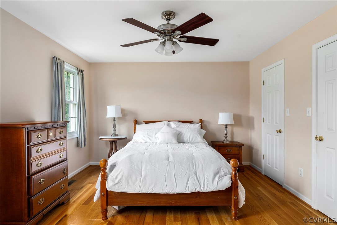 13514 Old Stage Road Hopewell, VA 23860 - Photo 23 of 42 a bedroom with a bed and dresser with wooden floor