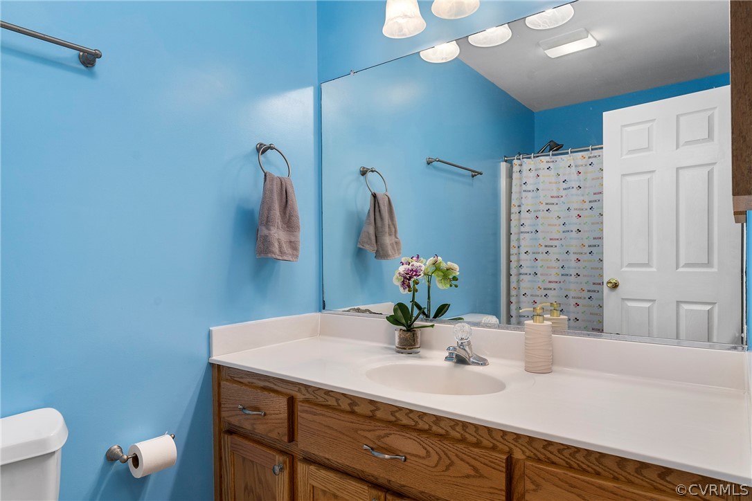 13514 Old Stage Road Hopewell, VA 23860 - Photo 30 of 42 a bathroom with a sink a toilet and mirror