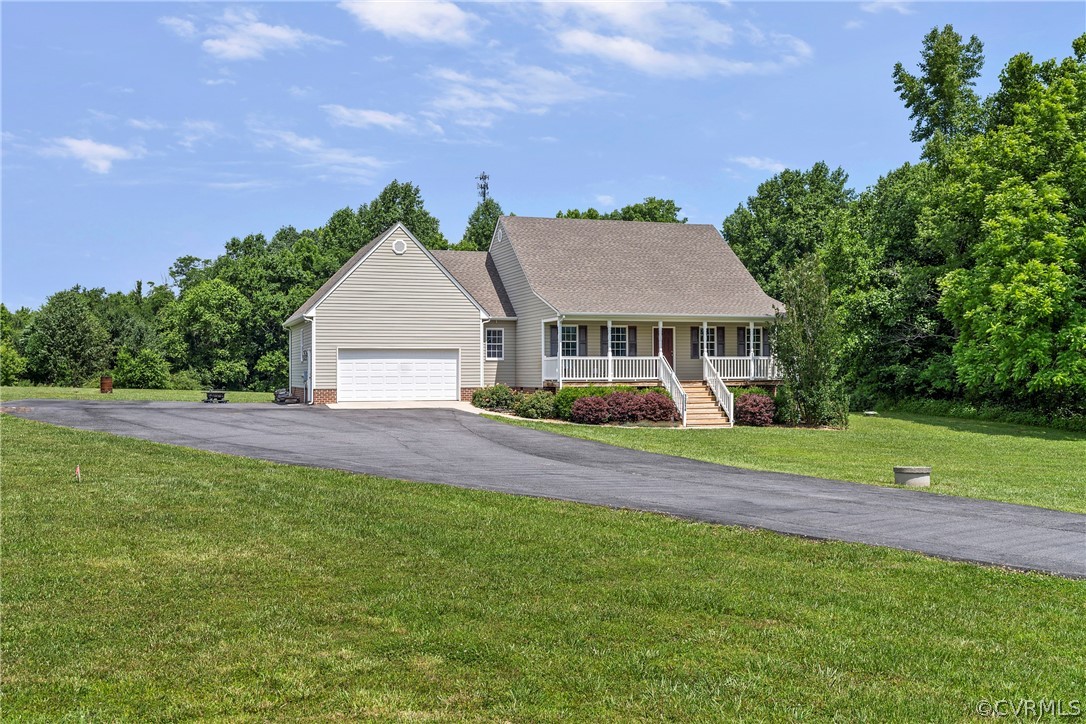 13514 Old Stage Road Hopewell, VA 23860 - Photo 3 of 42 a front view of a house with a yard and green space