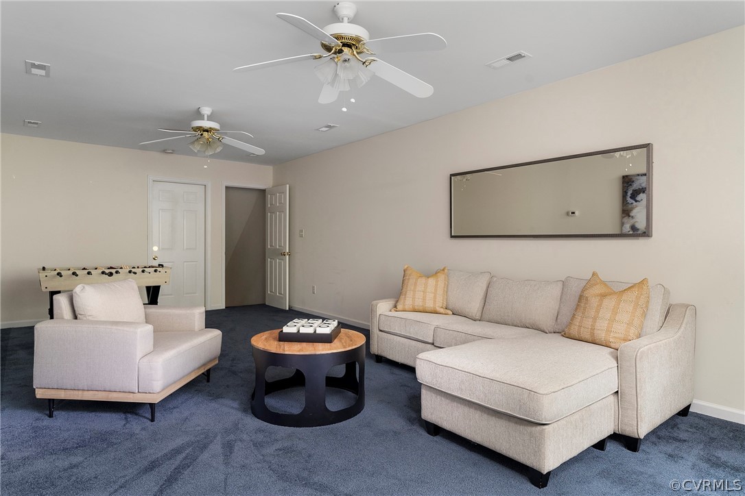 13514 Old Stage Road Hopewell, VA 23860 - Photo 31 of 42 a living room with furniture and a chandelier