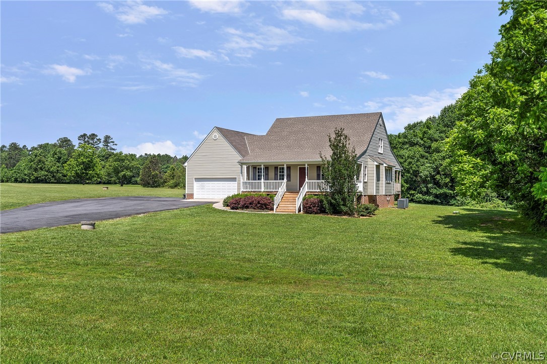 13514 Old Stage Road Hopewell, VA 23860 - Photo 6 of 42 a view of a house next to a big yard and large trees
