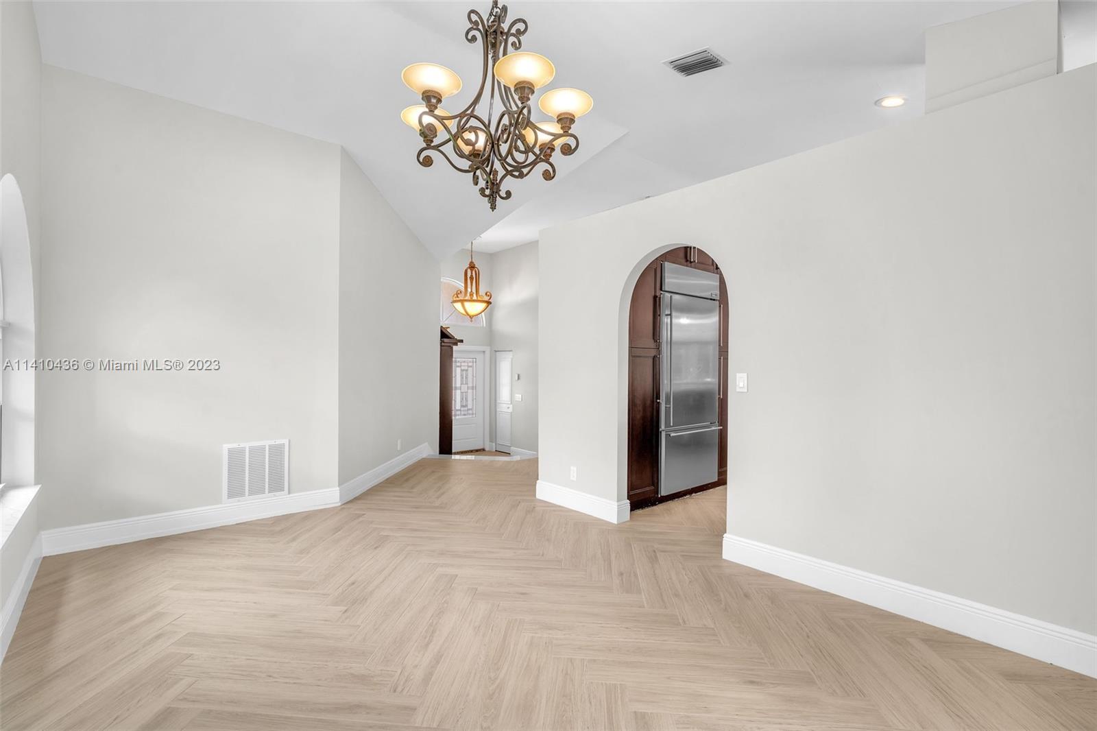 19440 Preserve Drive Boca Raton, FL 33498 - Photo 15 of 69 a view of a livingroom with a chandelier fan and wooden floor