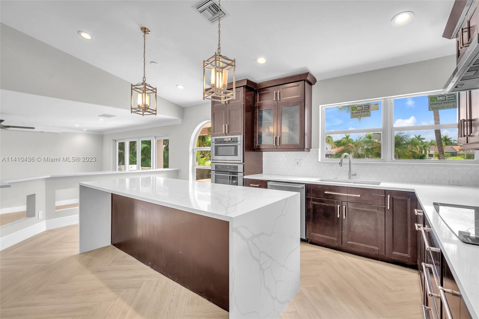19440 Preserve Drive Boca Raton, FL 33498 - Photo 17 of 69 a large kitchen with a large counter top space a sink stainless steel appliances and cabinets