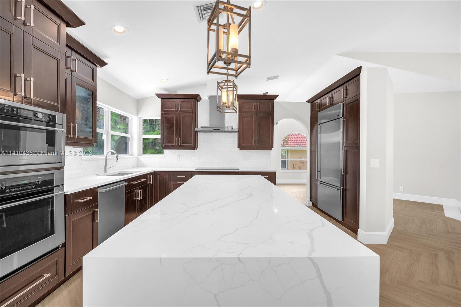 19440 Preserve Drive Boca Raton, FL 33498 - Photo 18 of 69 a large kitchen with stainless steel appliances kitchen island granite countertop a refrigerator a stove and a sink