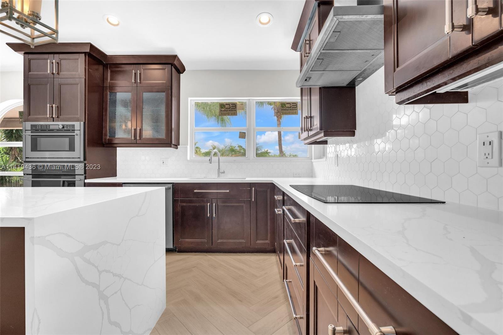 19440 Preserve Drive Boca Raton, FL 33498 - Photo 21 of 69 a kitchen with stainless steel appliances granite countertop a sink and a stove
