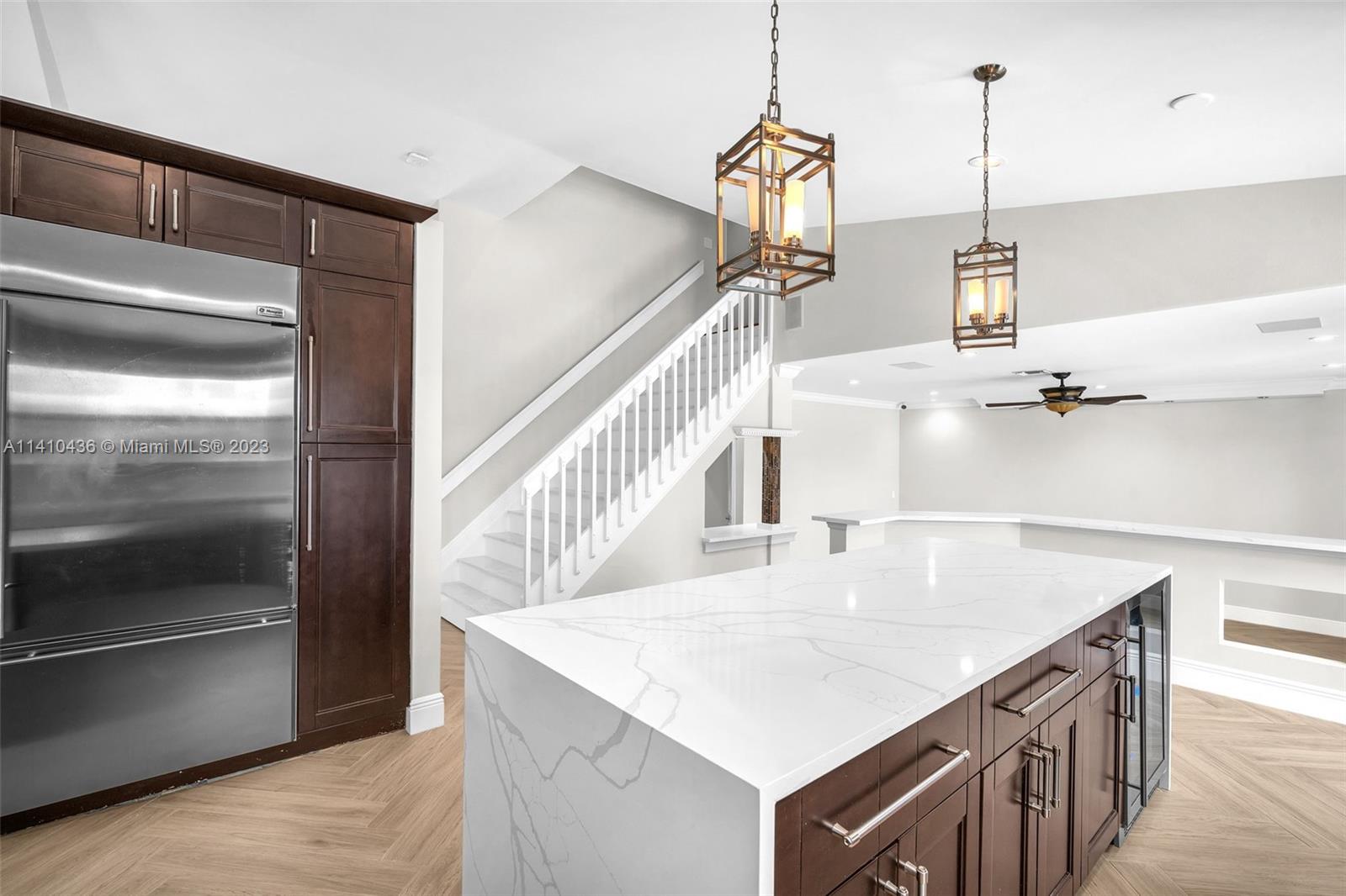 19440 Preserve Drive Boca Raton, FL 33498 - Photo 22 of 69 a kitchen with kitchen island white cabinets and stainless steel appliances
