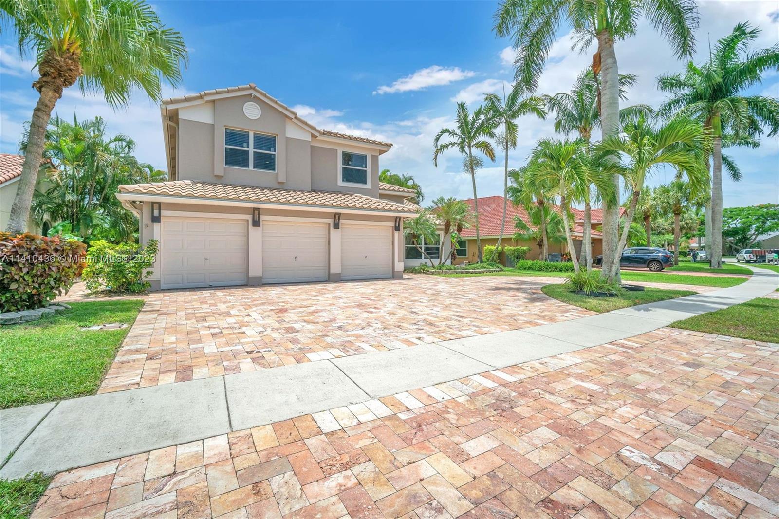 19440 Preserve Drive Boca Raton, FL 33498 - Photo 54 of 69 a front view of a house with a yard and trees