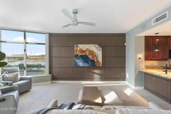 a living room with a couch and a floor to ceiling window