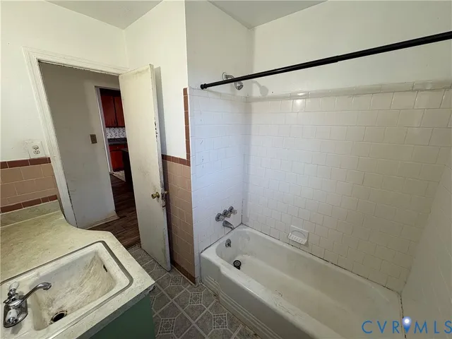 a bathroom with a tub and a shower