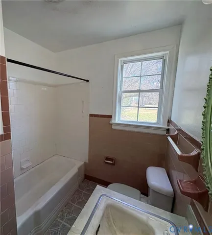 a bathroom with a tub toilet and sink