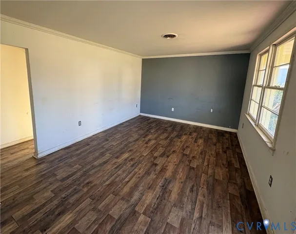 wooden floor in an empty room with a window