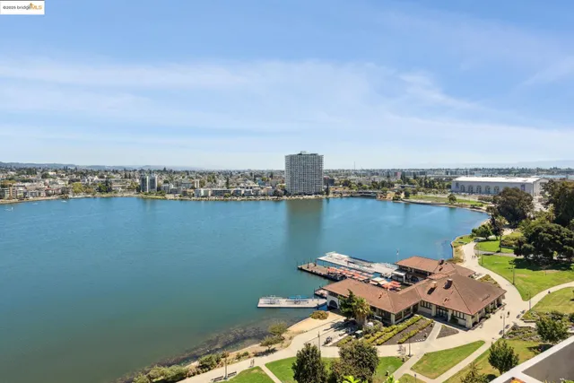 an aerial view of a house with outdoor seating space and lake view
