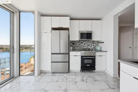 a kitchen with a refrigerator and a stove top oven