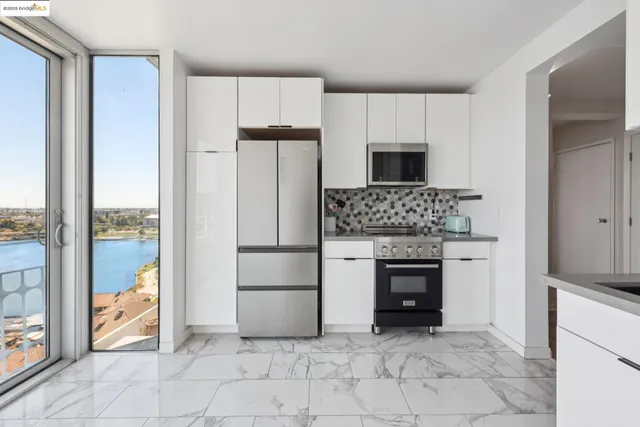 a kitchen with a refrigerator and a stove top oven