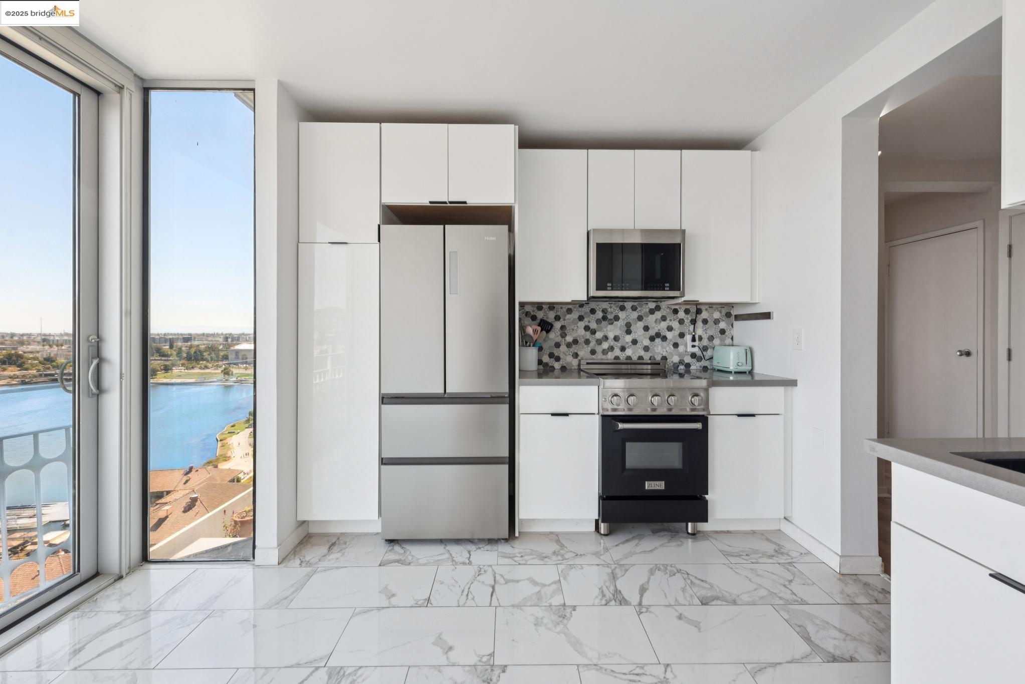1555 Lakeside Drive, Unit 190 Oakland, CA 94612 - Photo 21 of 45 a kitchen with a refrigerator and a stove top oven