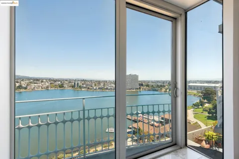 a view of a balcony with a floor to ceiling window next to a road