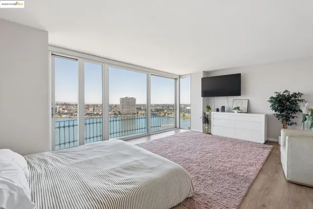 a bedroom with a bed and large window