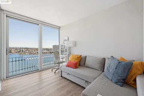 a living room with furniture and a floor to ceiling window