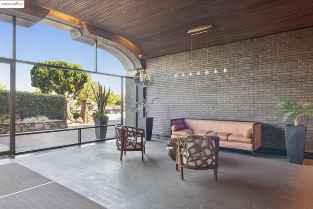 a view of a patio with a table and chairs and potted plants