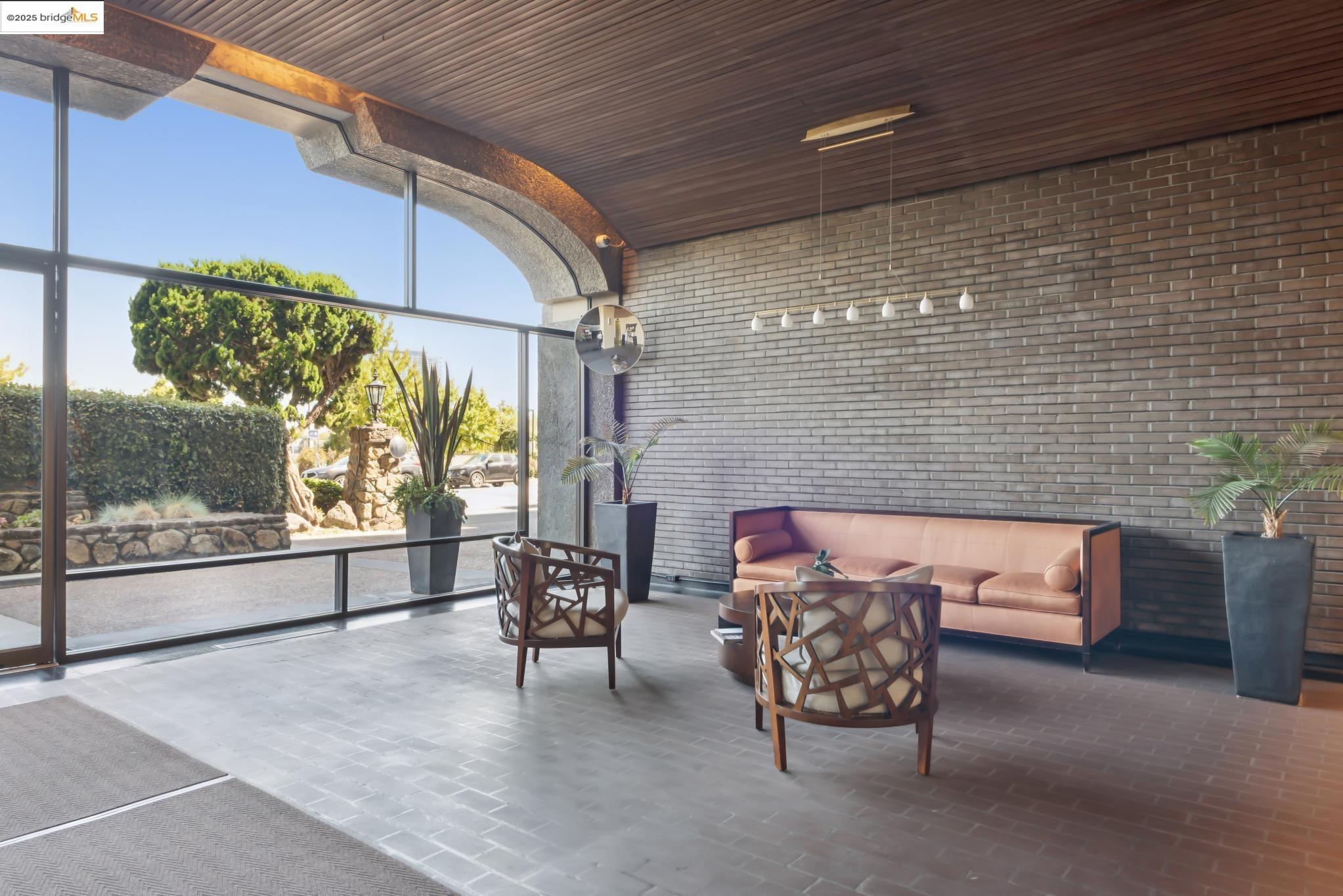 1555 Lakeside Drive, Unit 190 Oakland, CA 94612 - Photo 4 of 45 a view of a patio with a table and chairs and potted plants