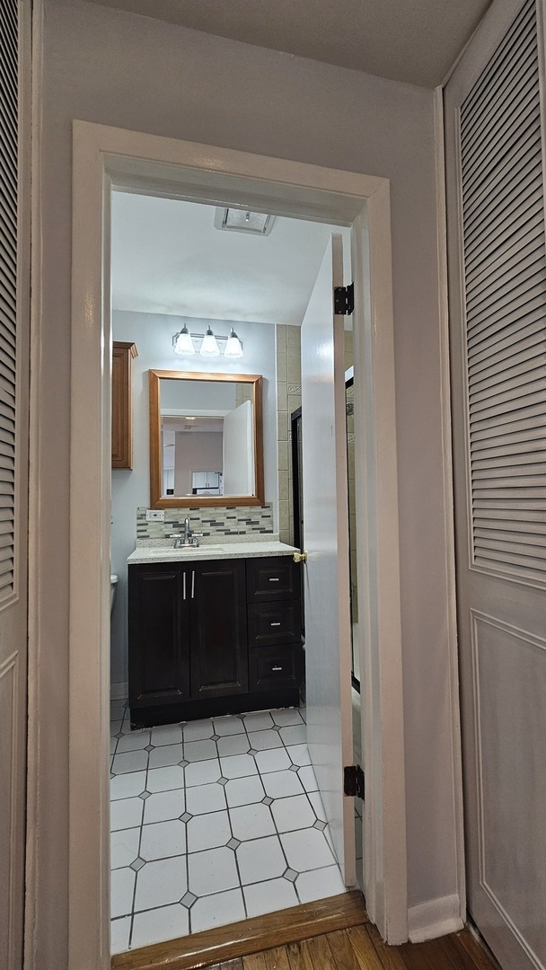 9588 Terrace Place, Unit 1C Des Plaines, IL 60016 - Photo 12 of 13 a bathroom with a sink and a mirror